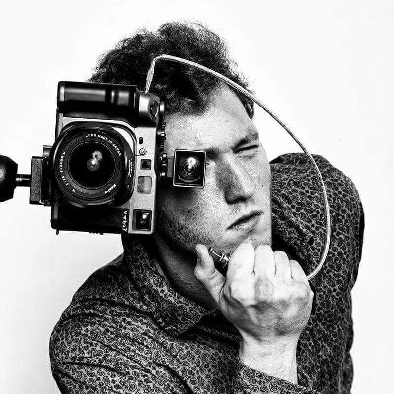 Photography intern with a film camera
