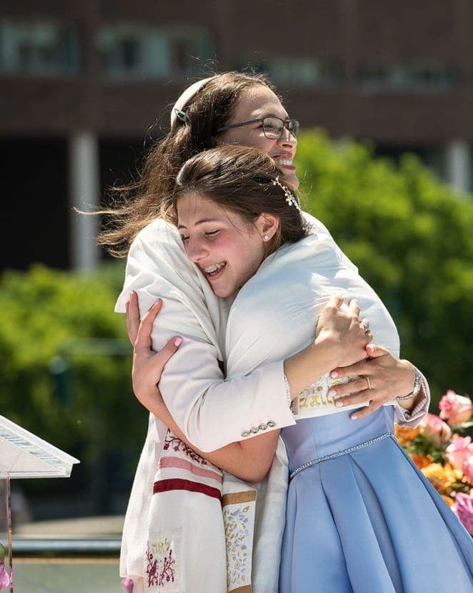 Bat mitzvah girl hugging her mother